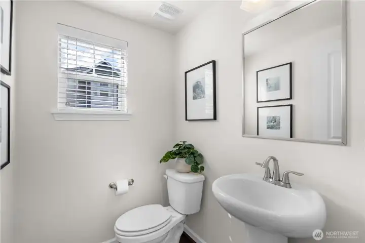 A guest powder room completes the main floor.