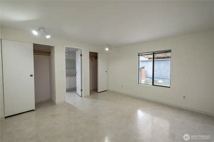 The large primary bedroom is connected to an ensuite bathroom with tub.