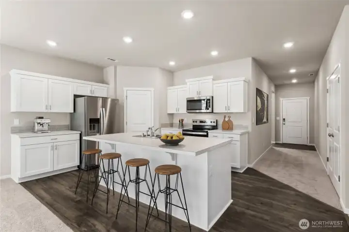 Virtually staged. Laminate flooring through main living spaces of the home. Photos are for representational purposes only. Colors and finishes may vary.