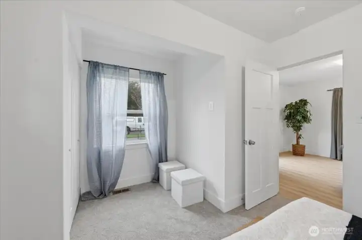 Closet area with extra room for a dresser.