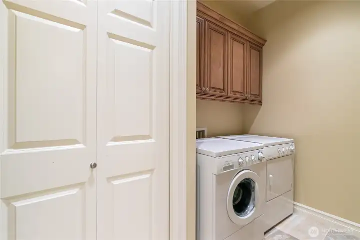Main floor laundry room with Frigidaire washer and dryer.  Large linen/storage closet,