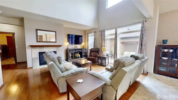 Vaulted ceiling with upper windows floods the living room with natural light.