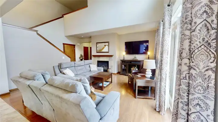 Gas fireplace and laminate hardwood flooring in living room