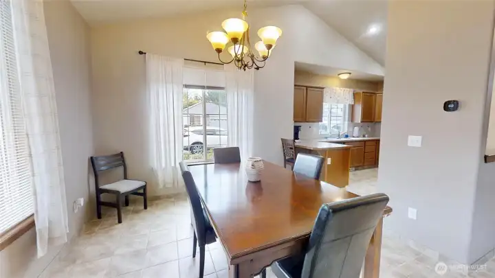 Dining room opens to kitchen with bar seat