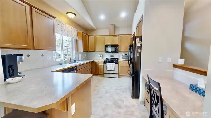 Kitchen features pantry and built in desk area and tile flooring
