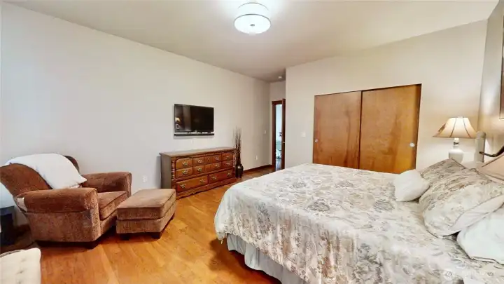 Spacious primary suite with laminate hardwood flooring