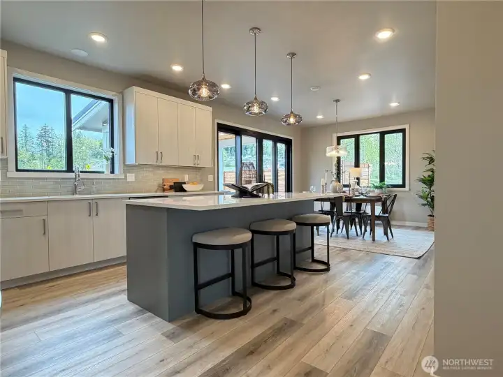 Spacious kitchen with lots of natural light and open to defined dining space.
