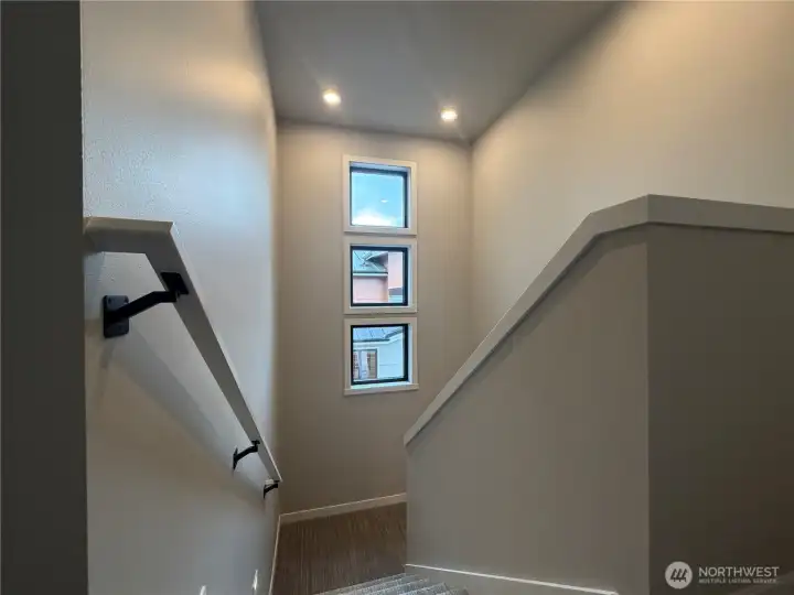 Stairwell windows provide more natural light.