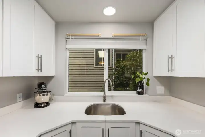 Stainless undermount sink with elevated valve