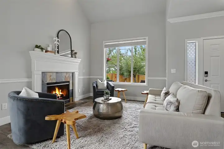 The stately living room features cathedral ceilings and a gas fireplace. The stately living room features cathedral ceilings and a gas fireplace.