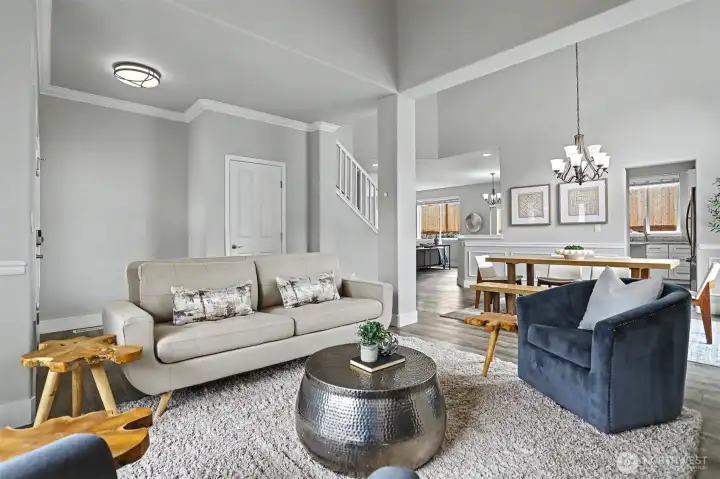 The living room flows openly into the adjacent formal dining area. The living room flows openly into the adjacent formal dining area.