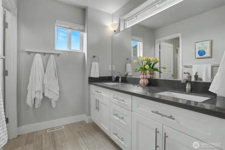 The second bathroom on the upper level was also just recently renovated with handsome Quartz countertops. Craftsman style cabinetry and tile flooring. The second bathroom on the upper level was also just recently renovated with handsome Quartz countertops. Craftsman style cabinetry and tile flooring.