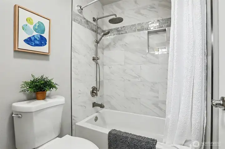 New designer ceramic tile just installed in second bathroom shower surround. New designer ceramic tile just installed in second bathroom shower surround.