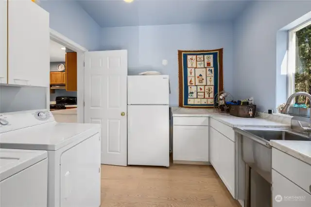 Utility room/mudroom located just off of the kitchen provides additional storage. Washer/dryer included.