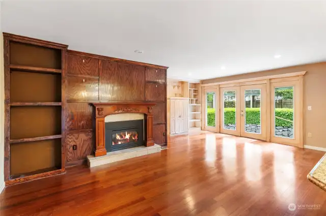 Large family room with gas fire place, built ins and French doors opening to the spacious yard creates and inviting space for relaxing and entertaining.