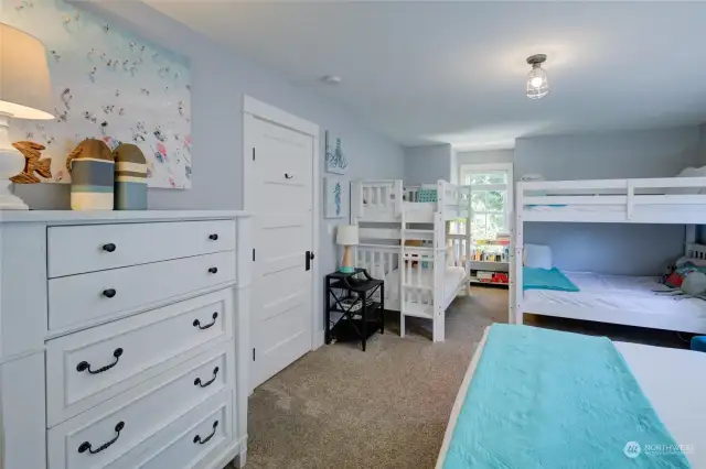 This room has a queen bed, full over full bunks and a set of twin bunks.  See the cute little reading nook behind?  This room is on point!