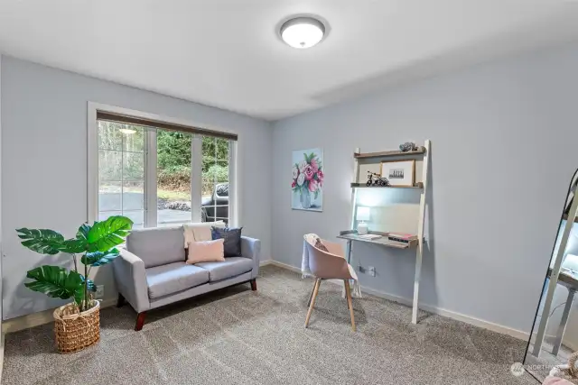 The main-level bonus room offers endless possibilities, whether as a home office, creative studio, playroom, or hobby space—enhanced by ample natural light.