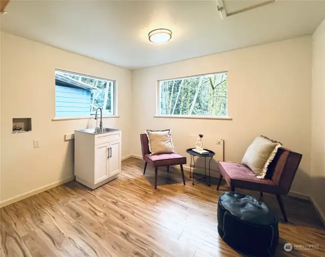 The laundry and pantry area, located just off the breakfast nook, provides functional convenience with updated flooring, a utility sink, and plenty of storage.