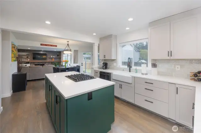 Amazing kitchen has island with storage on both sides and beverage fridge, double ovens and pantry.