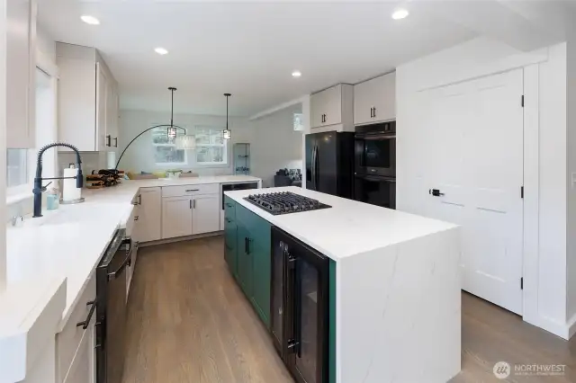 Amazing kitchen has island with storage on both sides and beverage fridge, double ovens and pantry.