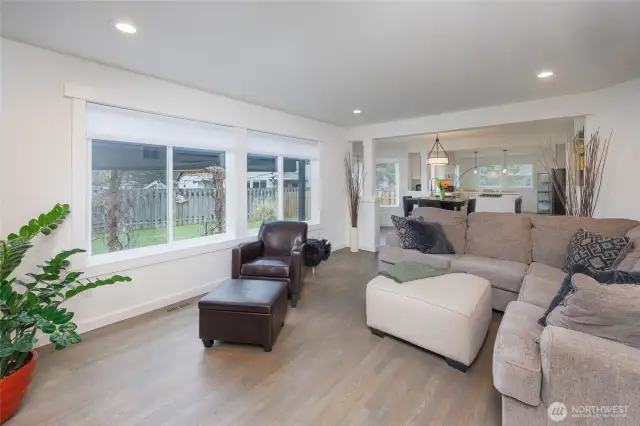 Family room has wall of windows and gas fireplace.
