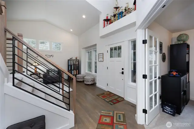 Open entry plan with high ceilings and skylights.