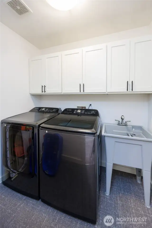 Upstairs laundry with utility sink.