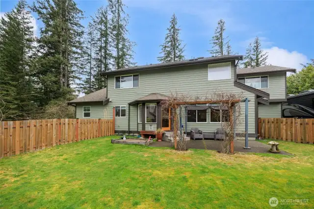 Fully fenced backyard with patio.