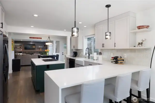 Amazing kitchen has island with storage on both sides and beverage fridge, double ovens and pantry.