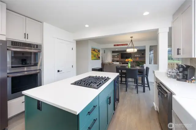 Amazing kitchen has island with storage on both sides and beverage fridge, double ovens and pantry.