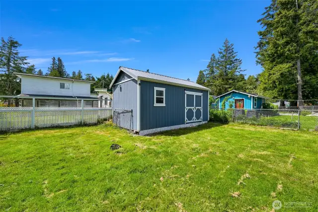 Large back yard with outbuilding and partially fenced