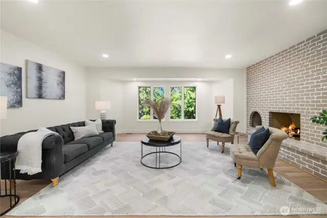 FAMILY ROOM OFF DINING ROOM WITH FIRE BURNING AND GREEN BELT BACKDROP.