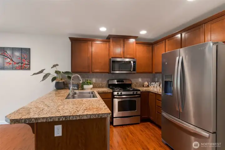 Well maintained kitchen with granite tile countertop. Kitchen faucet newly installed.