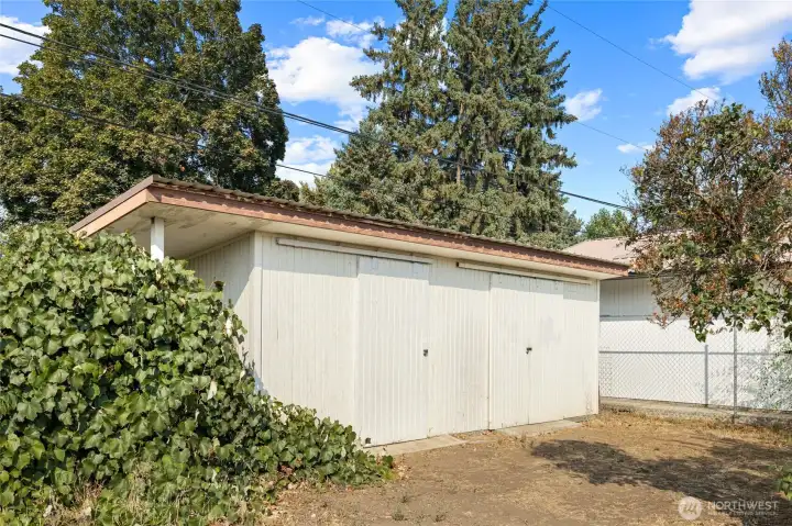 Storage shed with two separate spaces at the back of the property.
