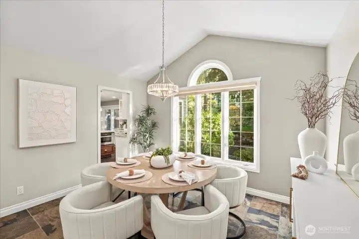 The dining room features a new chandelier, light and bright windows and a dramatic vaulted ceiling.