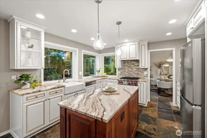 The wall of windows in the kitchen overlook the tranquil backyard and flood the room with natural light.
