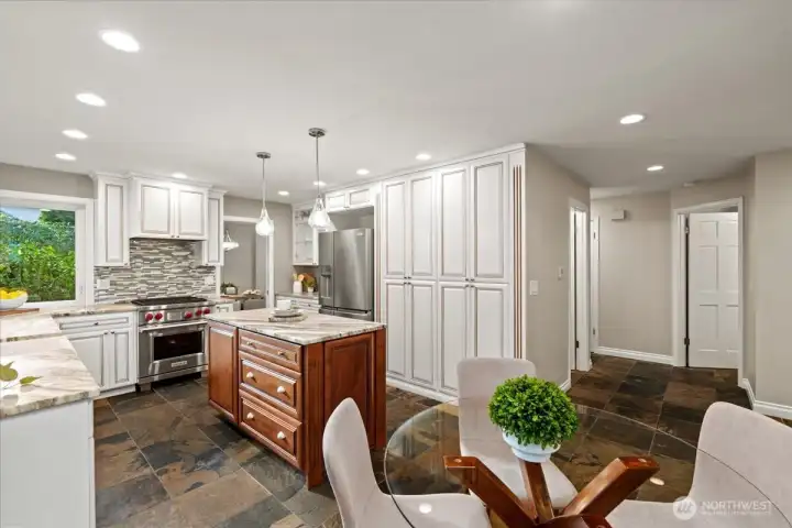 View of the breakfast nook with the doors to the main floor bath and mudroom beyond.
