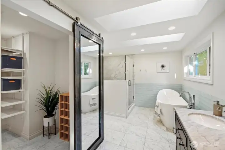 Step into the spa-like bathroom with a walk-in closet! So many features to mention in this 2019 studs-out bathroom remodel including all new plumbing, dual skylights, Carrara marble floors with radiant heat, oversized marble shower, Victoria + Albert volcanic limestone Amalfi slipper tub, Brizo faucets, electric hookup for smart toilet/washlet, dual vanity with Carrara marble counters and so much more!