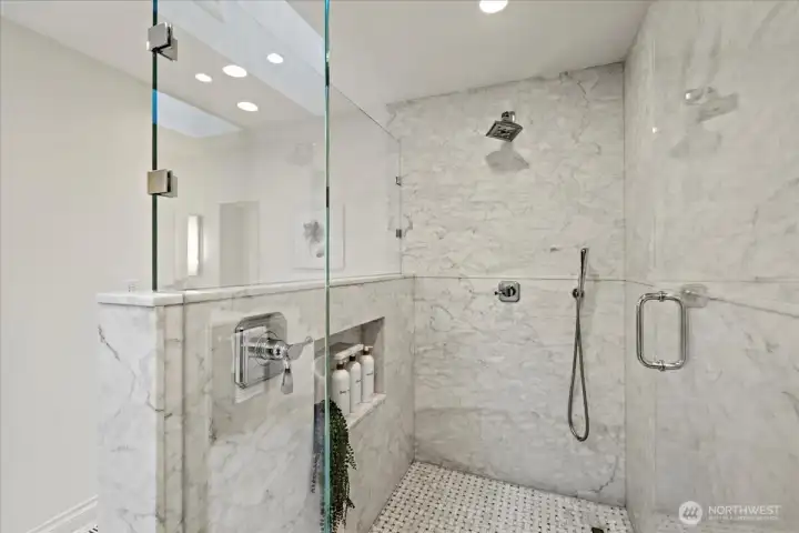 Wash away the stress of the day in this luxurious marble shower with Brizo fixtures and a bonus hand sprayer.