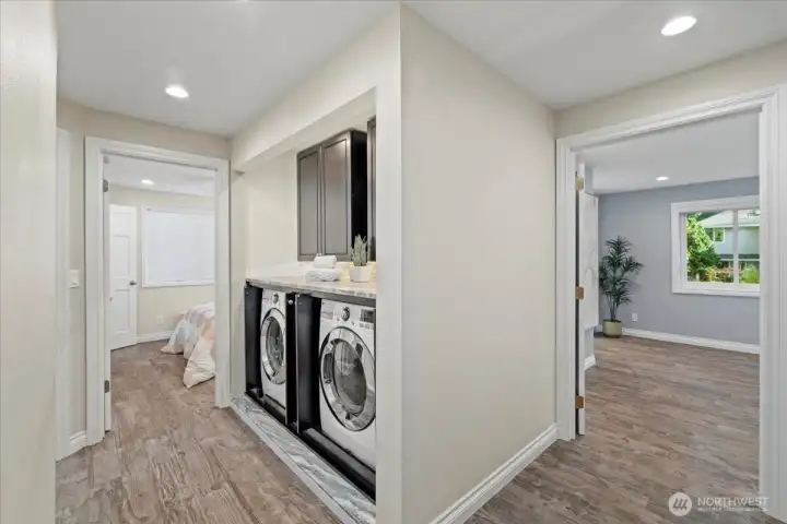 View of laundry area with cabinet doors open.