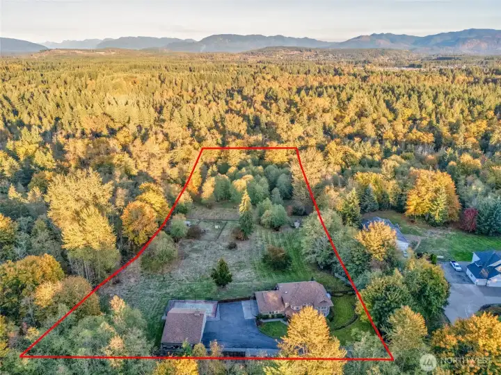 Beautifully maintained acreage surrounded by mature landscaping.