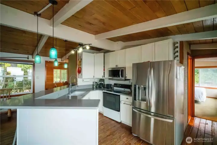 Open concept kitchen with quartz counter tops & wrap around eating bar.