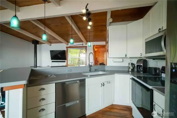Open concept kitchen with quartz counter tops & wrap around eating bar.