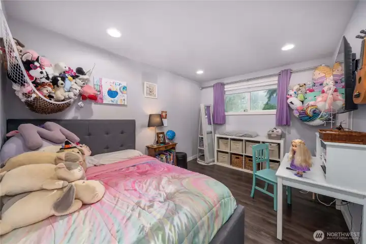Unit 2 - A comfortable second bedroom with durable vinyl plank flooring and a wide window that brings in natural light. Ideal as a guest room, nursery, or home office — perfect for house-hackers or multi-use living.