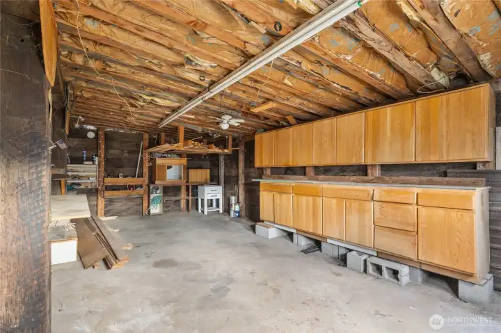 Generous garage with storage cabinets.