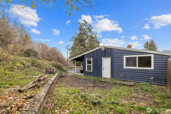 Raised garden bed and fruit trees.