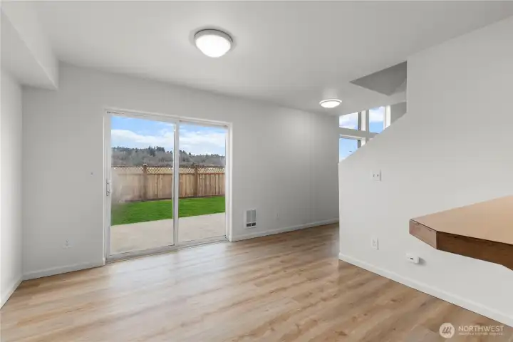 Sliding glass door leads to large yard and patio