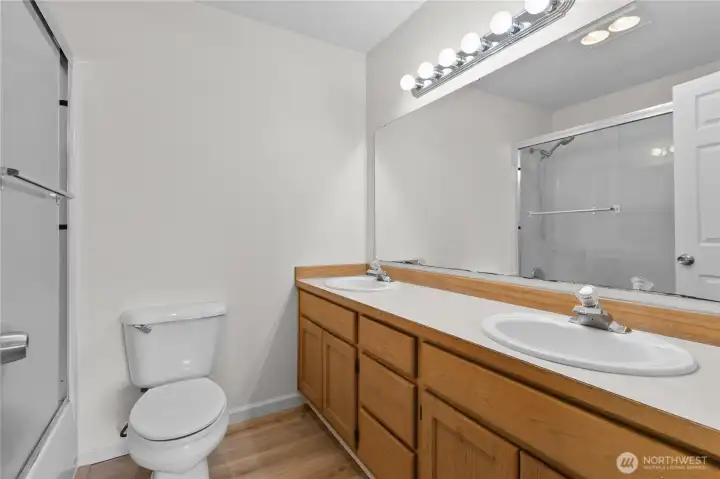 Primary attached full bathroom with double-sink vanity