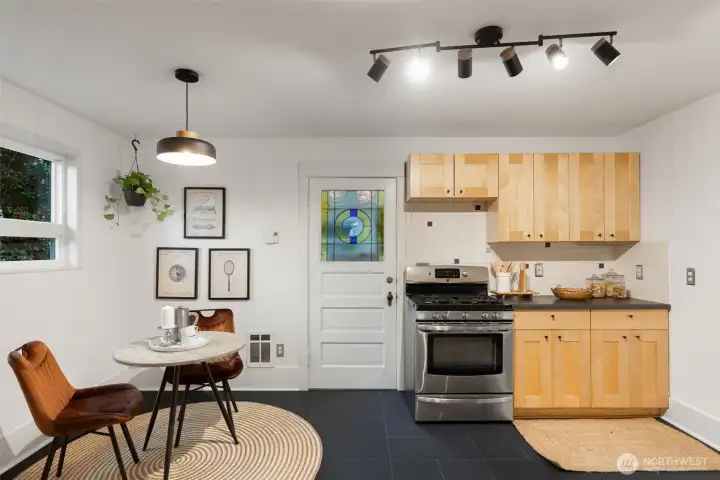 Kitchen with an eating nook. New kitchen floor tile, paint and light fixtures.