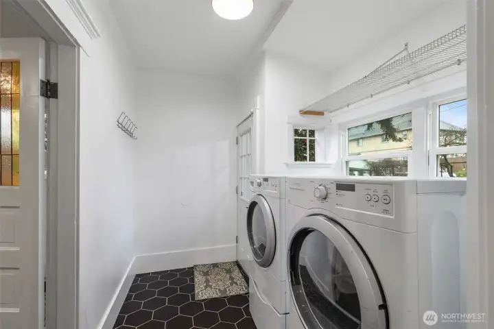 Remodeled laundry room and mud room with access to the fully fenced backyard and garage.